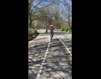 Guy rides unicycle with two sticks park