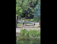 Guy face between legs of girl on large chair