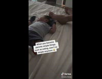 Dad eats while caresses his foot on sons head