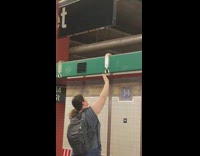 Woman plays with subway light 