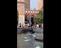 Man ride bike balance sofa on water fountain