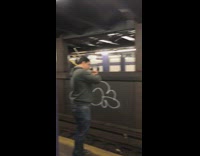 Guy plays violin together with another guy playing cello across subway station