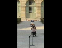 Woman handstand leg split shorts Paris mansion