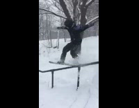 Collab JerrySlams - Snowboarder grinds rail with board and lands on his stomach and ribs slow motion