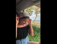 Girl wave gold cloth  beach windy afternoon