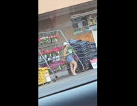 Woman with two plants poses outside Lowe's