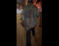 Dog on backpack of man walk street