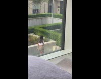 Plaid shorts girl films tiktok dance hedge 