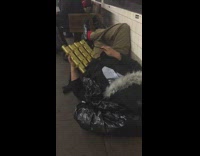 Guy lays on the floor at subway station and strikes a note on small golden xylophone #BluePointWhatTheL