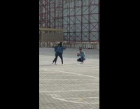 Two girls denim jacket dance pavement scaffolding