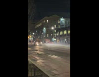 Tow truck dragging another vehicle on fordham street