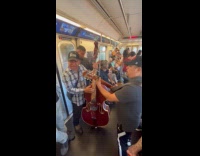 Collab WINY - Two men with instrument performs inside train