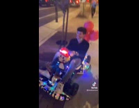 Cop rides mario go kart down sidewalk 
