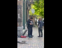 Man use angle grinder on metal street