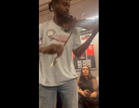 Guy plays violin during the train ride