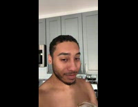 Shirtless guy making coffee at home 