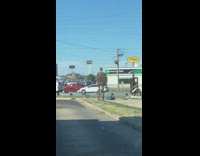 IITW - Man lays down on floor taking pictures of statue