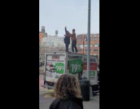 Two guys ballroom dancing on top of parked uhaul truck