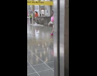 Woman with something hanging out of butt at subway station