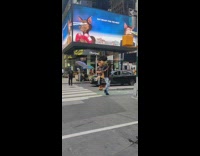 Guy wears costume of bear carrying guy 