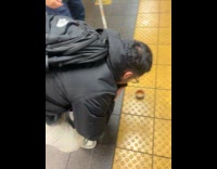 Old man gets phone from subway tracks