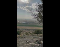 View of the desert with clear sky and dark clouds