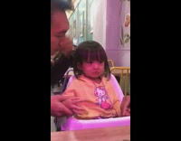 Toddler girl in baby seat holding in tears