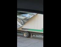 Truck gets caught and stuck under the bridge 