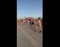 Woman black shorts show butt at Coachella 