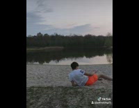 Guy neon orange shirt flip fail sand 