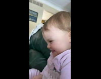 Baby play feeding black dog and laughing 