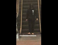 Lady black jacket with hammer and sandals walking backwards escalator