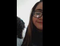 Small black and white dog humping black shaggy dog on bed girl glasses