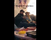 Man taking selfie with dog at party