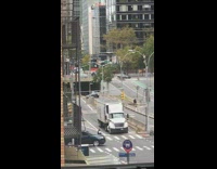 Black vest guy dances directs traffic street