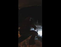 Guy rides sled down mountain at night 