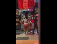 2 ladies bend over cashier counter 