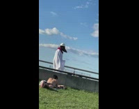 Man bird mask white robe walk sun bathing