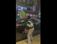 Sanitation worker tosses bags of garbage into truck 