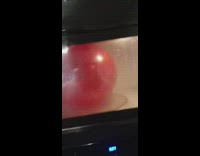 Red balloon pops inside the microwave oven