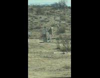 Blonde woman hold rifle desert white SUV