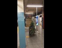 Guy wearing christmas tree plays instrument station 