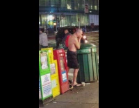 shirtless man shorts plays flute