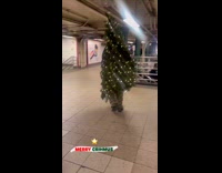 Christmas tree walks inside the subway station