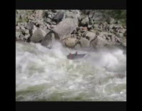 Red shirt guy rides grey inflatable boat 