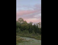 View sunrise pink sky brown cabin house 