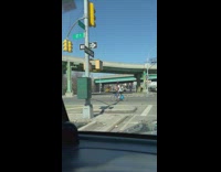 Guy balancing ball on head while riding bike