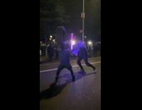 2 men playfighting with light sabers 