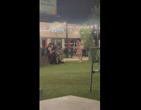 Woman in a mouse costume tiktok dance at the park