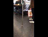 Guy riding subway with a school desk